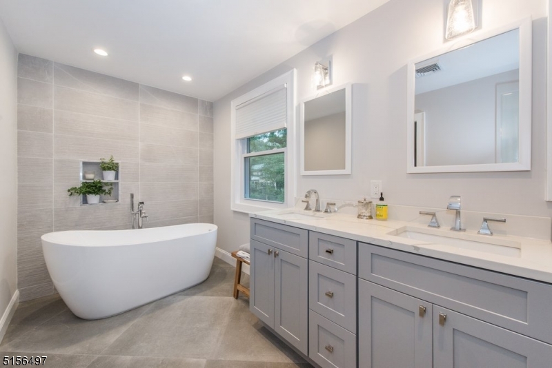 32 Parsonage Hill Road Short Hills, NJ 07078 - Photo 25 of 47 a spacious bathroom with a double vanity sink mirror and a bathtub