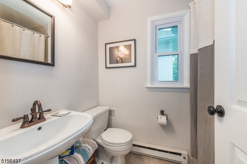 32 Parsonage Hill Road Short Hills, NJ 07078 - Photo 27 of 47 a bathroom with a toilet a sink and mirror