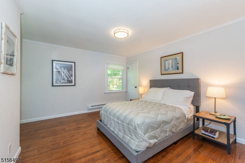 32 Parsonage Hill Road Short Hills, NJ 07078 - Photo 28 of 47 a bedroom with a bed and a lamp