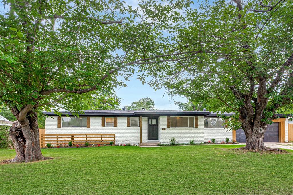 3816 Springbranch Drive Benbrook, TX 76116 - Photo 23 of 25 a front view of a house with a garden and trees