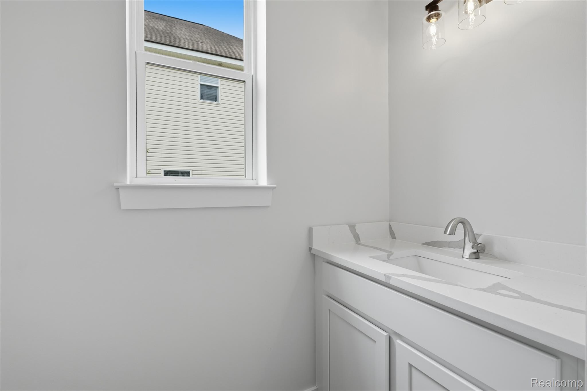 9400 Roland Brighton, MI 48116 - Photo 13 of 41 Powder room with quartz countertop.