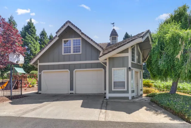 a dining room with wooden floor and a chandelier