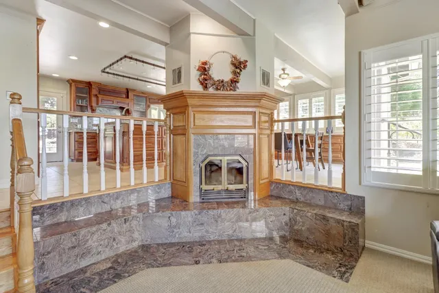 a dining hall with stainless steel appliances granite countertop a table and chairs