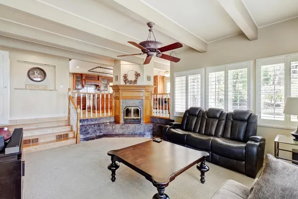a dining hall with stainless steel appliances granite countertop a table and chairs