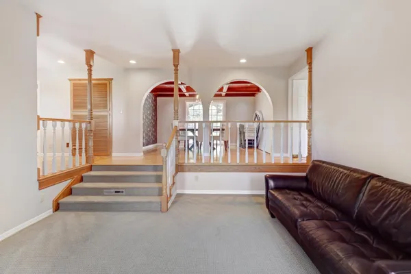 a view of hallway with a window and wooden floor