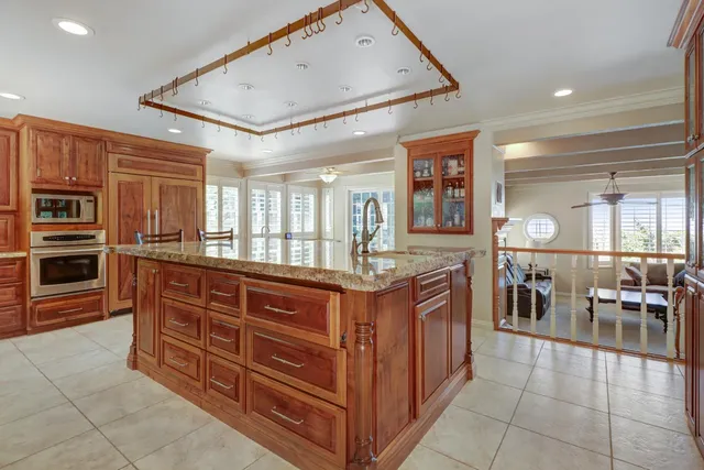 a view of a street with a bench and trees around