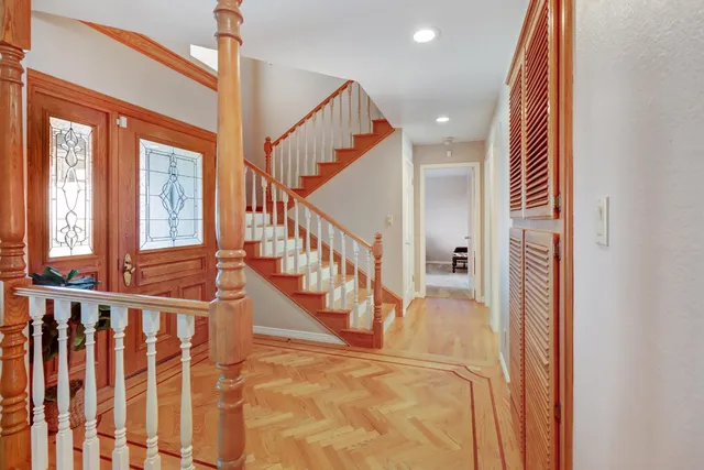 a view of a patio with table and chairs potted plants and large tree