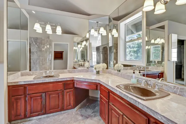 an aerial view of a house with a yard and lake view