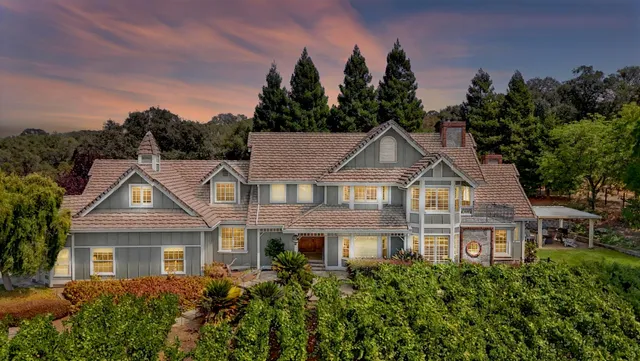 a kitchen with granite countertop stainless steel appliances a stove sink and cabinets