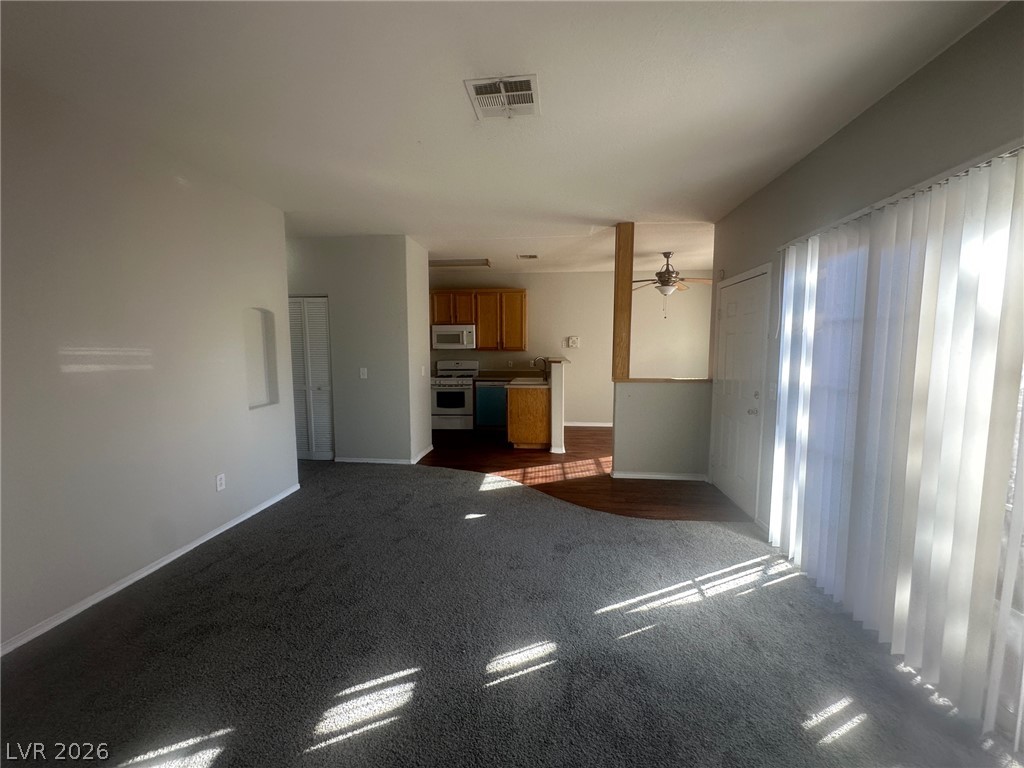 4730 East Craig Road, Unit 1073 Las Vegas, NV 89115 - Photo 18 of 18 An open floorplan seamlessly connects the carpeted living area to the kitchen beyond.