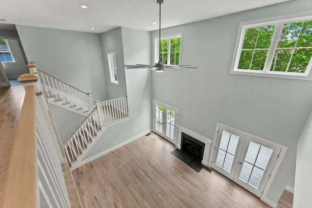 a living room with fireplace furniture and a wooden floor