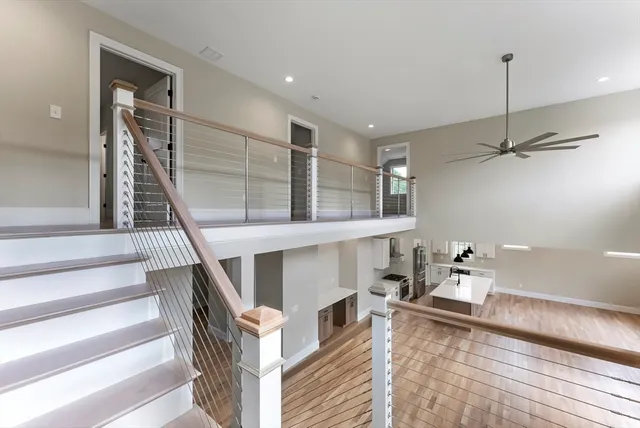 a kitchen with stainless steel appliances kitchen island a sink a refrigerator and cabinets