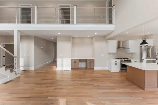 a kitchen with white cabinets and a fireplace