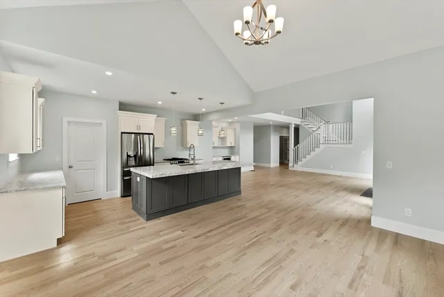 a bathroom with a granite countertop sink a toilet and shower