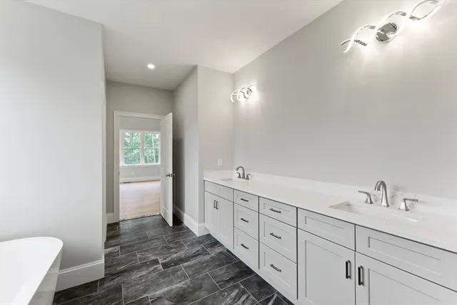 a bathroom with a sink a toilet and a window