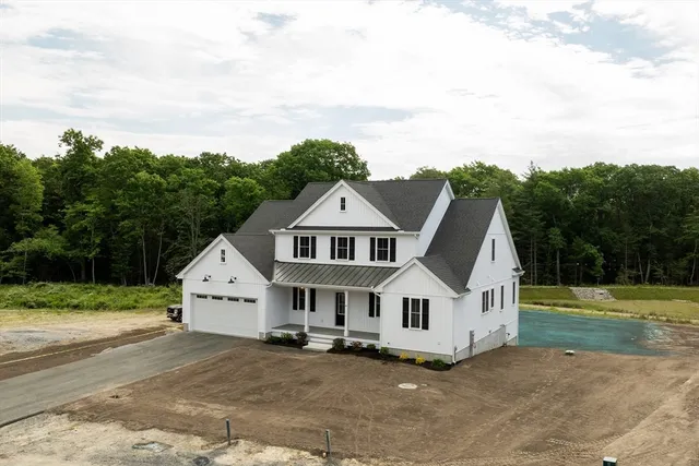 an aerial view of a house with a yard and roof