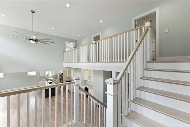 a view of an empty room with window and fire place