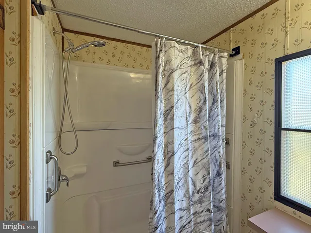a bathroom with a shower and a shower curtain