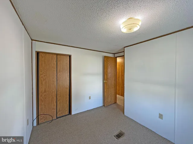 an empty room with a window and painted walls