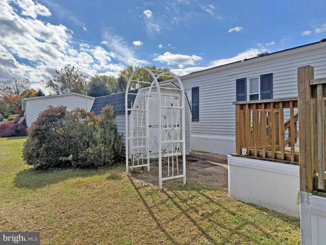 a view of wooden house with a wooden fence