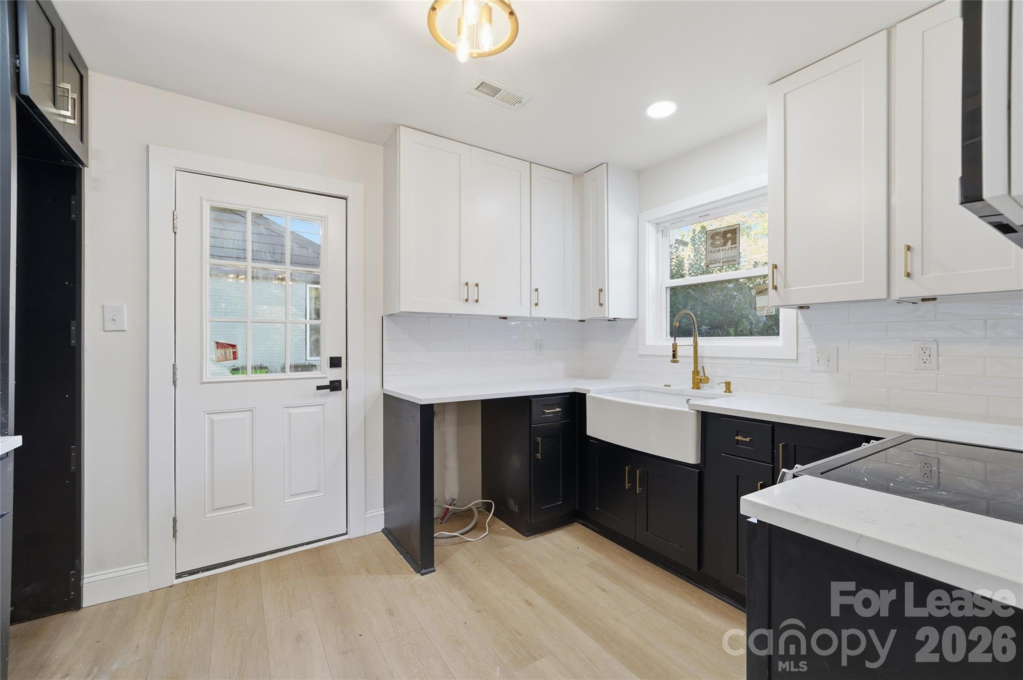 1320 Anderson Street Charlotte, NC 28205 - Photo 6 of 13 a kitchen with a sink cabinets and window