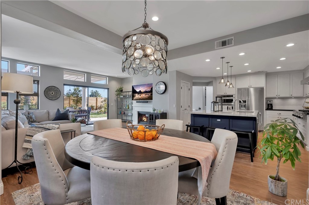 3235 Star Canyon Circle Corona, CA 92882 - Photo 14 of 75 a dining room with furniture a chandelier and kitchen view