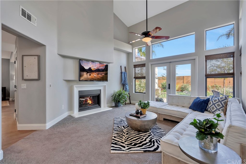 3235 Star Canyon Circle Corona, CA 92882 - Photo 24 of 75 a living room with furniture a fireplace and a chandelier