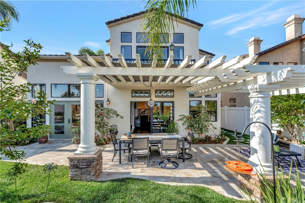 3235 Star Canyon Circle Corona, CA 92882 - Photo 33 of 75 a view of a patio with table and chairs potted plants and large tree
