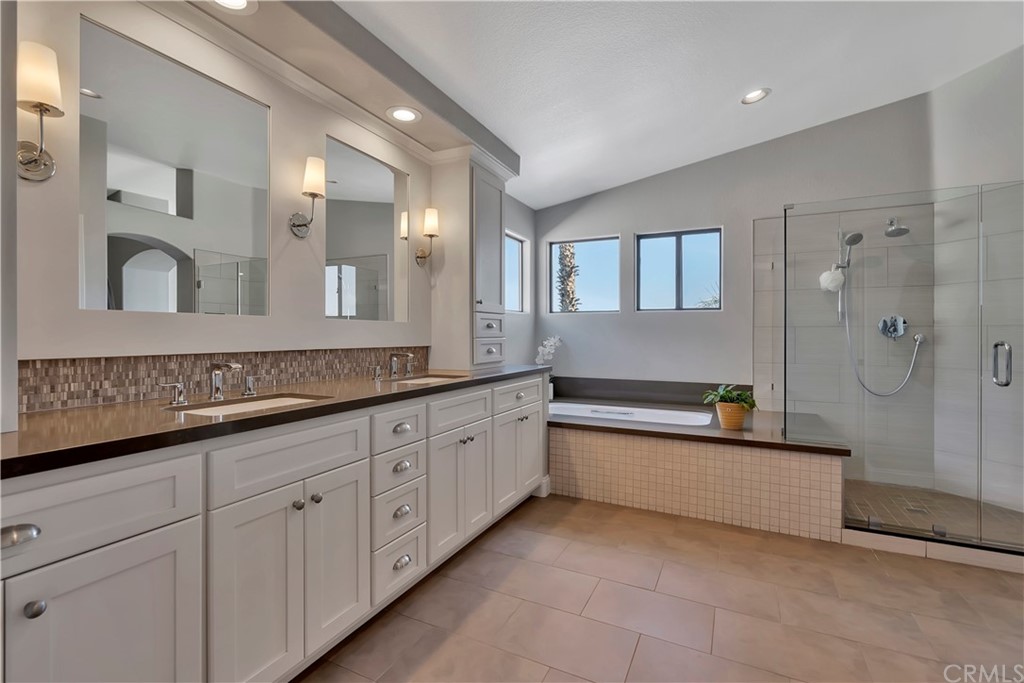 3235 Star Canyon Circle Corona, CA 92882 - Photo 44 of 75 a spacious bathroom with a granite countertop sink mirror and bathtub
