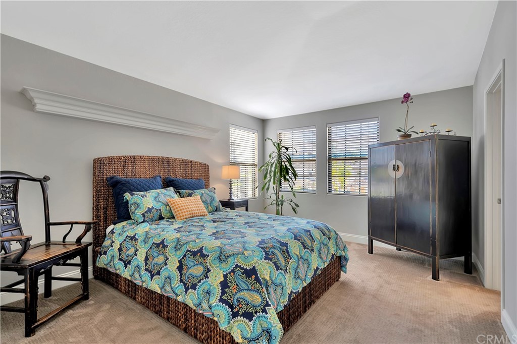 3235 Star Canyon Circle Corona, CA 92882 - Photo 54 of 75 a bedroom with a large bed and a chandelier