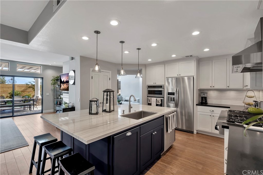 3235 Star Canyon Circle Corona, CA 92882 - Photo 61 of 75 a kitchen with stainless steel appliances kitchen island granite countertop a kitchen island hardwood floor sink and stove