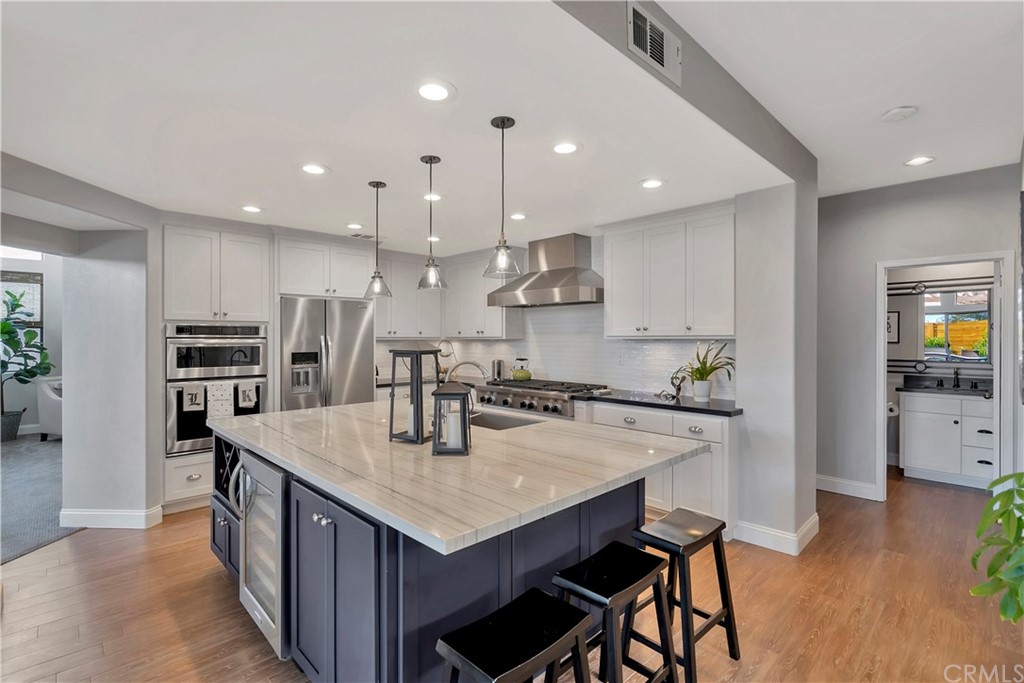 3235 Star Canyon Circle Corona, CA 92882 - Photo 10 of 75 a kitchen with stainless steel appliances granite countertop a kitchen island a stove a table and chairs