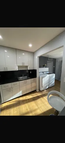 a kitchen with granite countertop a stove and a sink