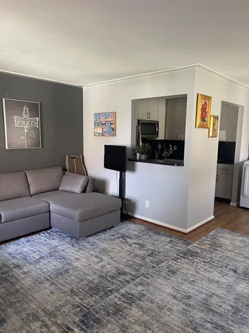 a living room with hard wood flooring and furniture