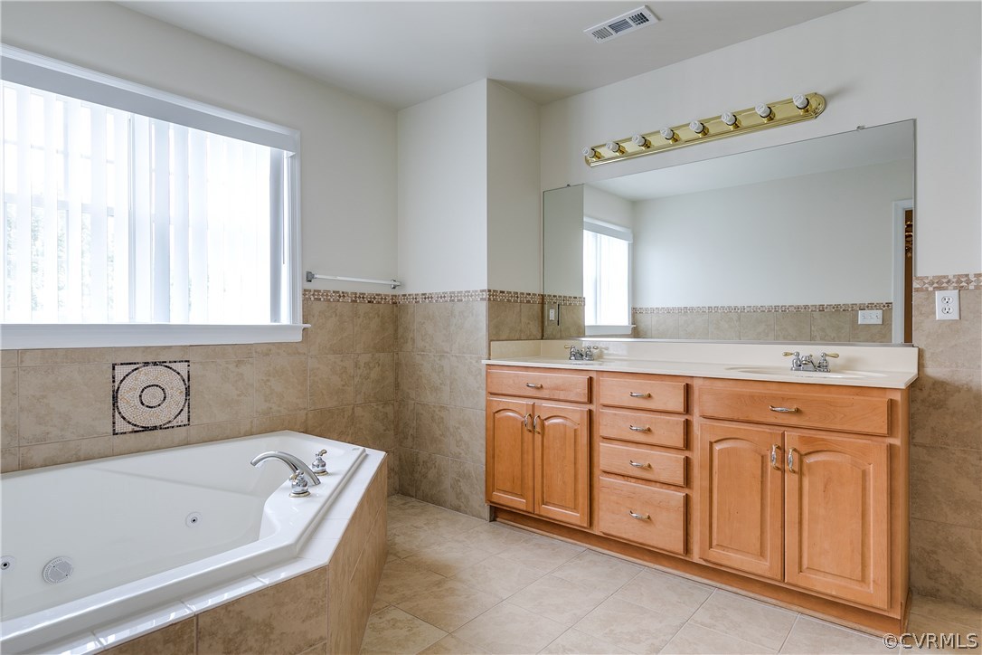 1418 Goswick Ridge Road Midlothian, VA 23114 - Photo 25 of 47 a bathroom with a tub sink and a mirror