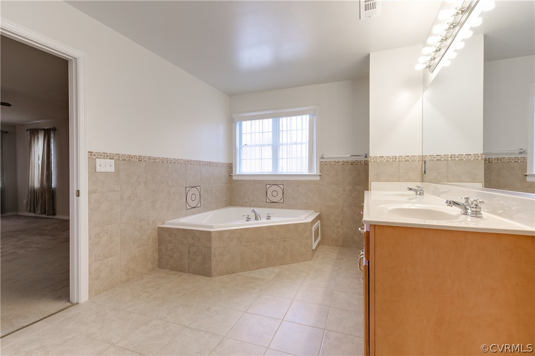 1418 Goswick Ridge Road Midlothian, VA 23114 - Photo 26 of 47 a bathroom with a bathtub and sink
