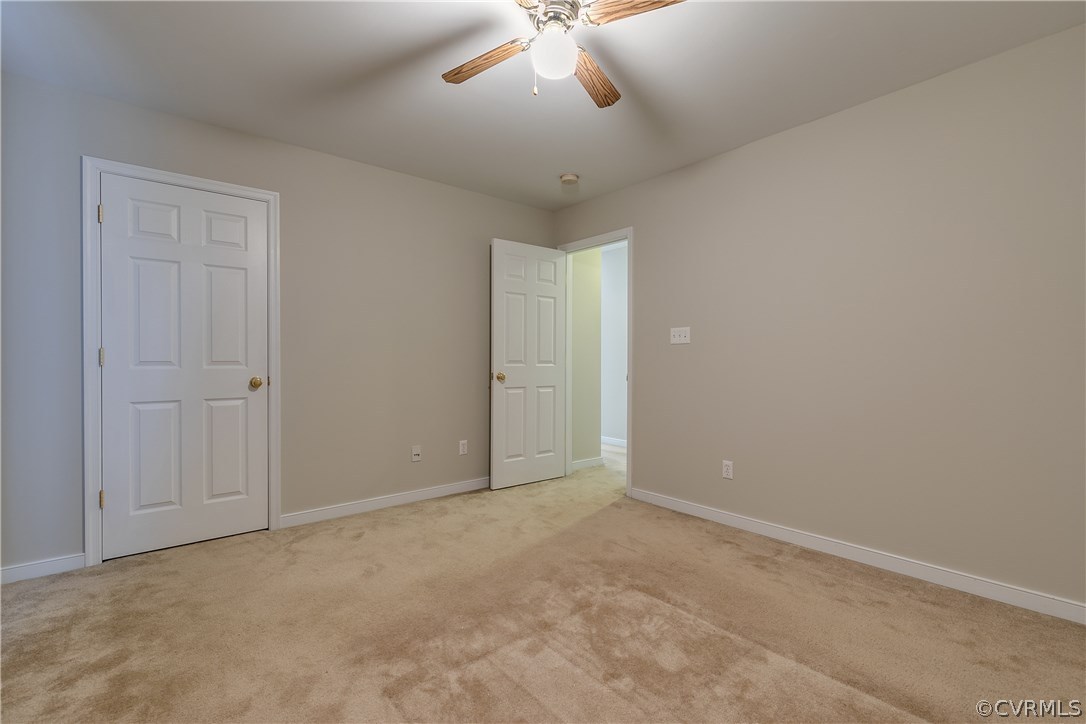 1418 Goswick Ridge Road Midlothian, VA 23114 - Photo 32 of 47 an empty room with a chandelier fan