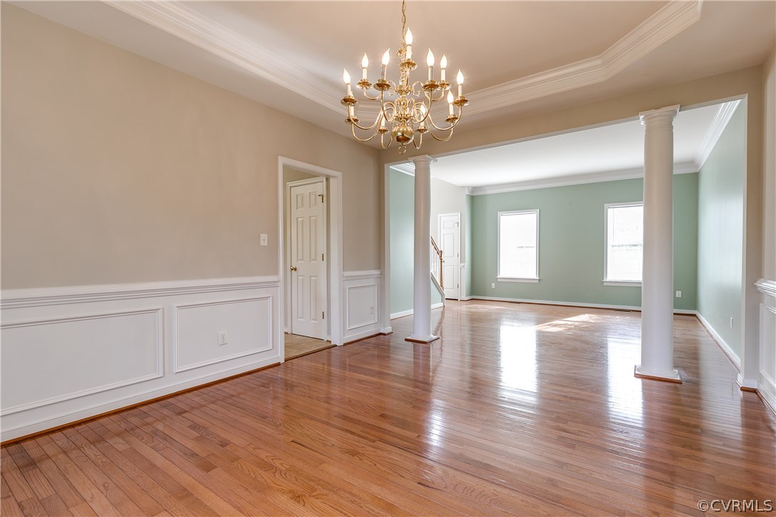 1418 Goswick Ridge Road Midlothian, VA 23114 - Photo 9 of 47 a view of an empty room with wooden floor and a chandelier