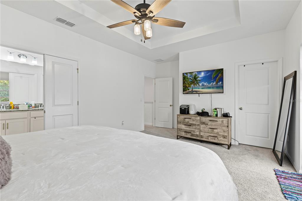 5119 Jones Road St. Cloud, FL 34771 - Photo 15 of 41 a bedroom with a bed and a flat screen tv