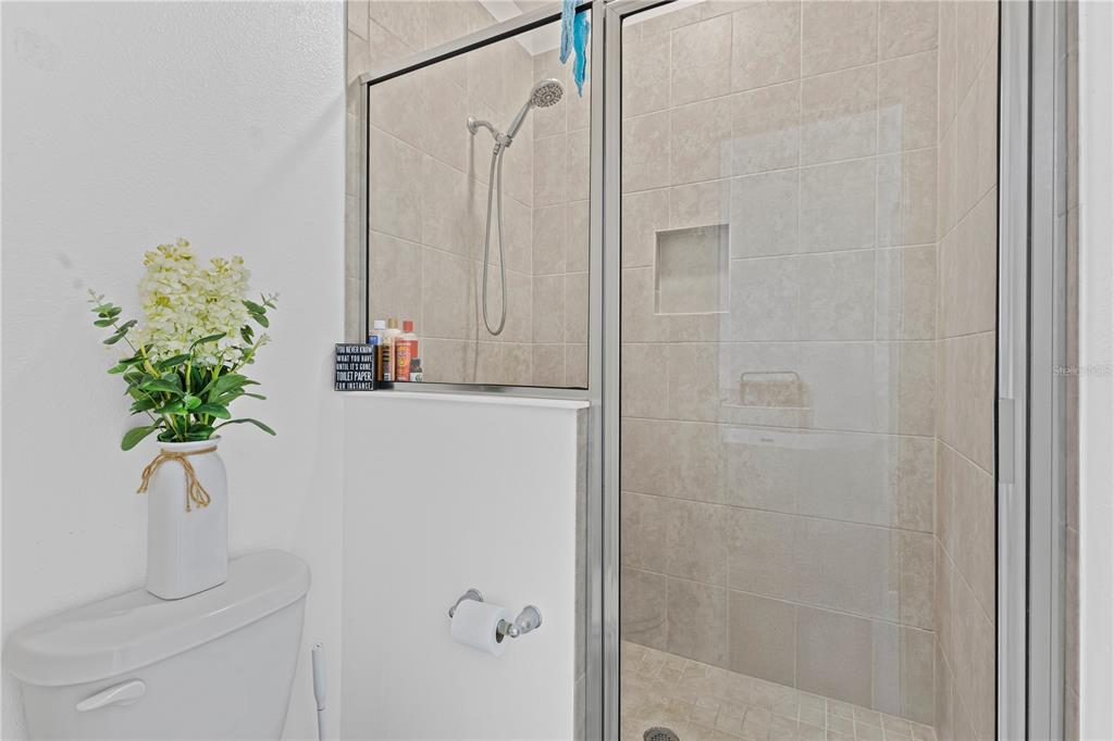 5119 Jones Road St. Cloud, FL 34771 - Photo 18 of 41 a bathroom with a shower curtain