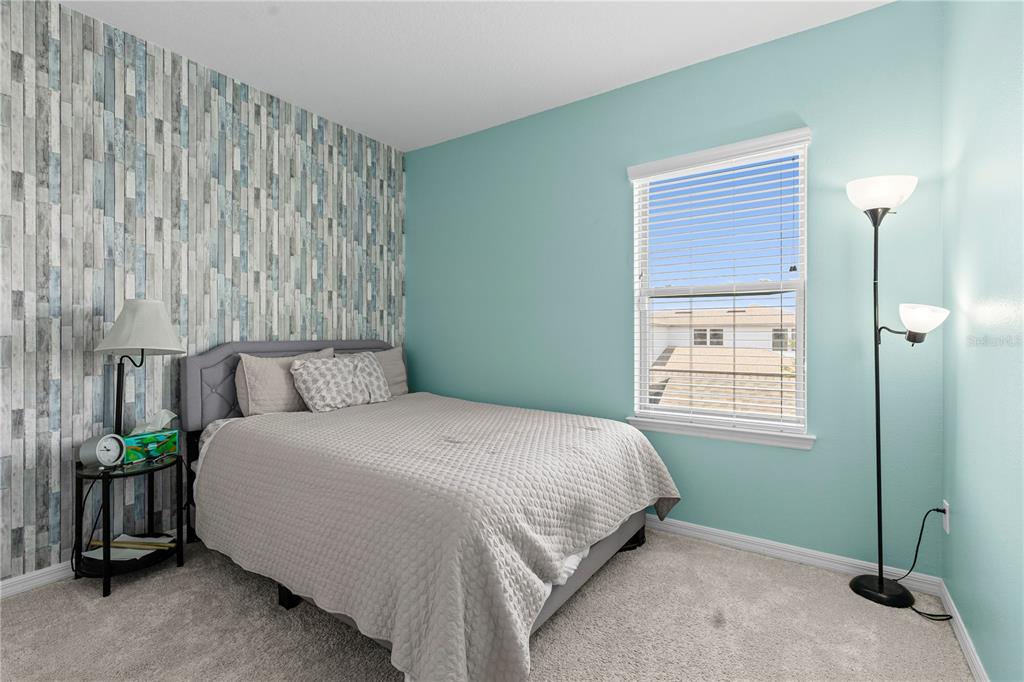 5119 Jones Road St. Cloud, FL 34771 - Photo 23 of 41 a bedroom with a bed table and a window