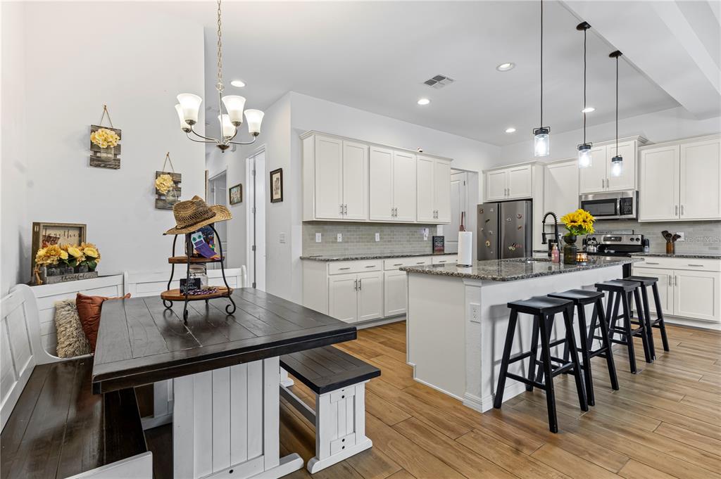 5119 Jones Road St. Cloud, FL 34771 - Photo 6 of 41 a kitchen with kitchen island granite countertop a sink a center island and cabinets