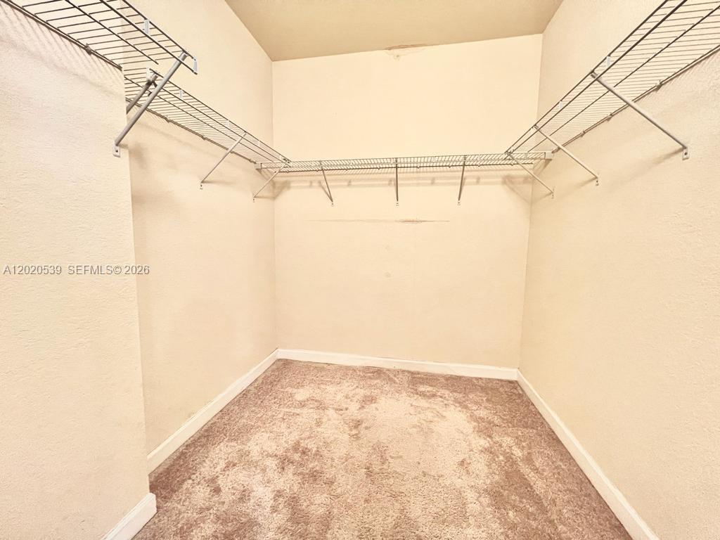 17001 Southwest 96th Street Miami, FL 33196 - Photo 16 of 23 a view of a room with racks on the wall
