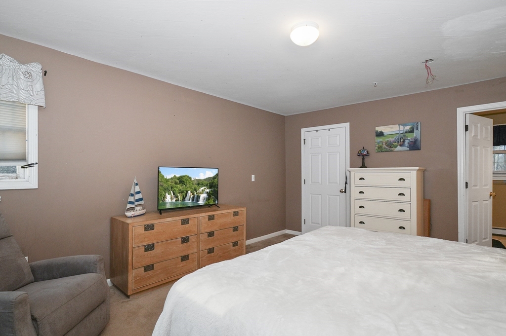 24 North End Road Townsend, MA 01469 - Photo 21 of 35 a bedroom with a bed and a couch