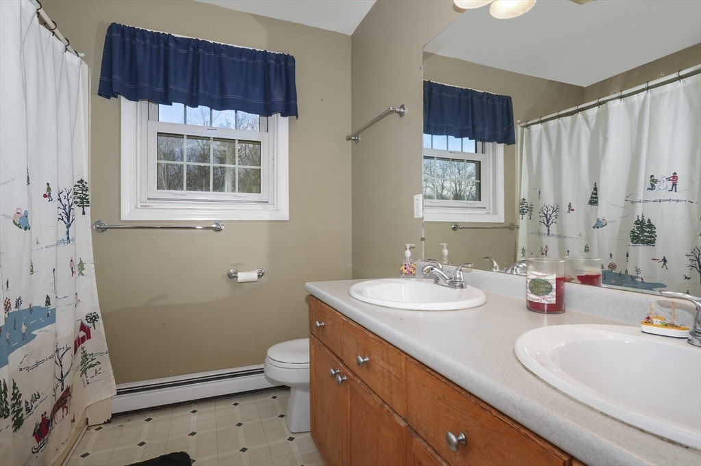 24 North End Road Townsend, MA 01469 - Photo 22 of 35 a bathroom with a sink a toilet and shower
