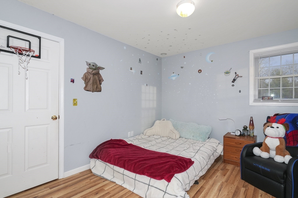 24 North End Road Townsend, MA 01469 - Photo 27 of 35 a bedroom with a bed and wooden floor