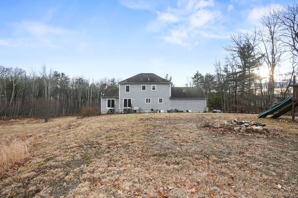 24 North End Road Townsend, MA 01469 - Photo 30 of 35 a large tree in front of a house with a yard