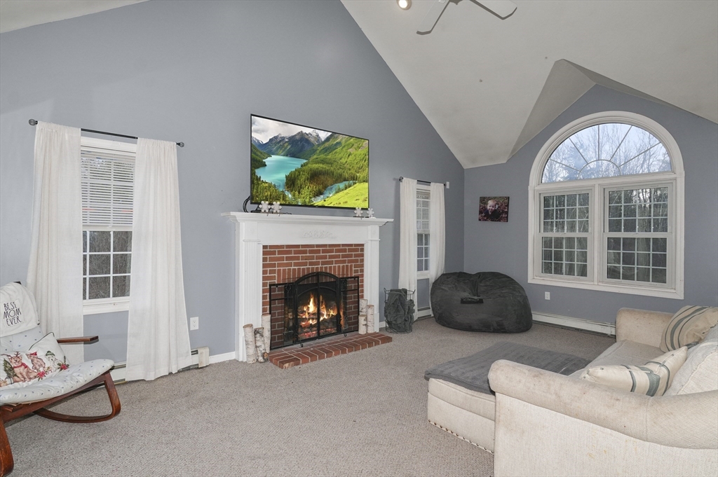 24 North End Road Townsend, MA 01469 - Photo 3 of 35 a living room with furniture a fireplace and a flat screen tv