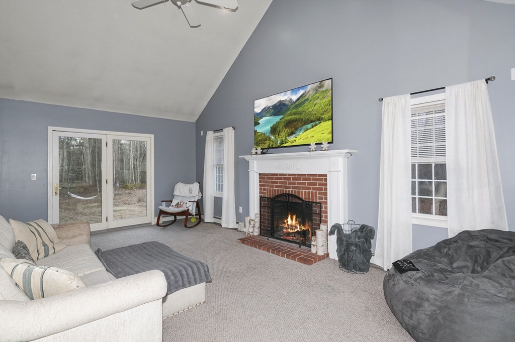24 North End Road Townsend, MA 01469 - Photo 4 of 35 a living room with furniture a flat screen tv and a fireplace