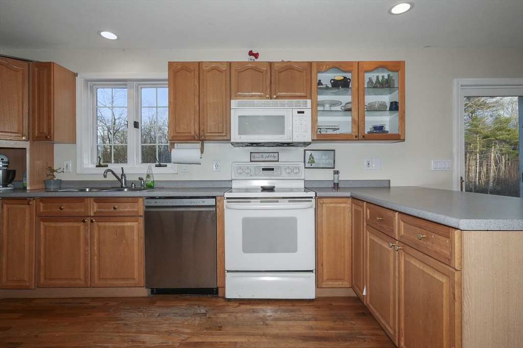 24 North End Road Townsend, MA 01469 - Photo 6 of 35 a kitchen with stainless steel appliances granite countertop a sink stove and cabinets